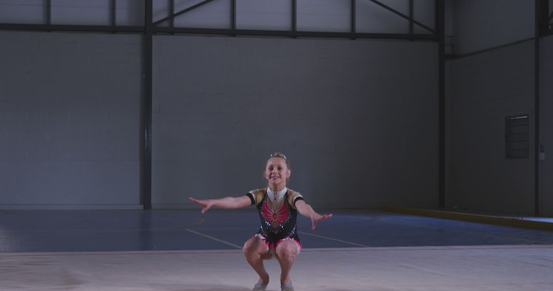 Young girl performing gymnastics routine in indoor sports arena - Free Images, Stock Photos and Pictures on Pikwizard.com