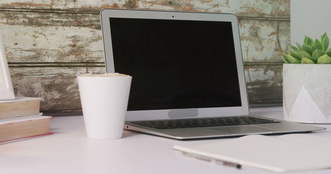 Open Laptop on Desk with Coffee Mug and Plant - Free Images, Stock Photos and Pictures on Pikwizard.com