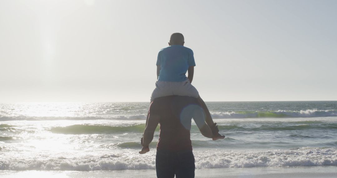 Father Carrying Son on Shoulders at Seaside - Free Images, Stock Photos and Pictures on Pikwizard.com