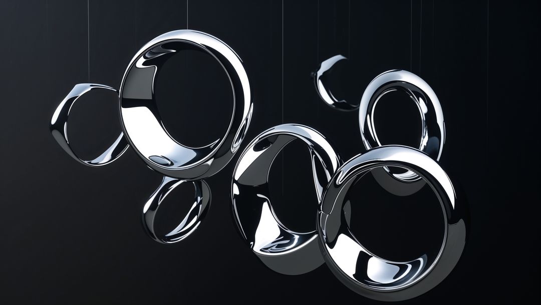 Metallic Chrome Rings Suspended in Dark Studio
