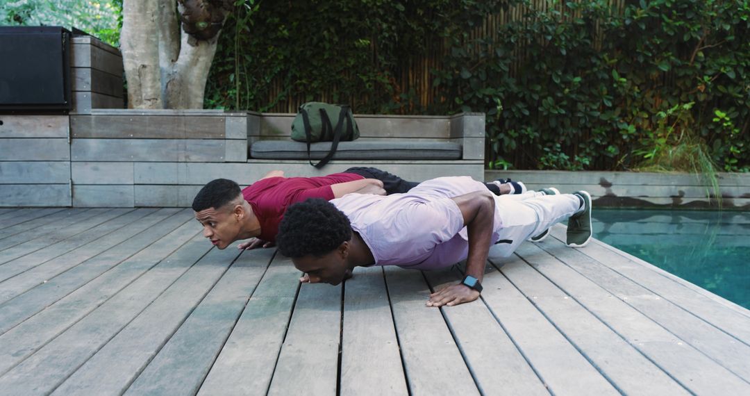 Active Friends Exercising Outdoors by Pool on Sunny Day