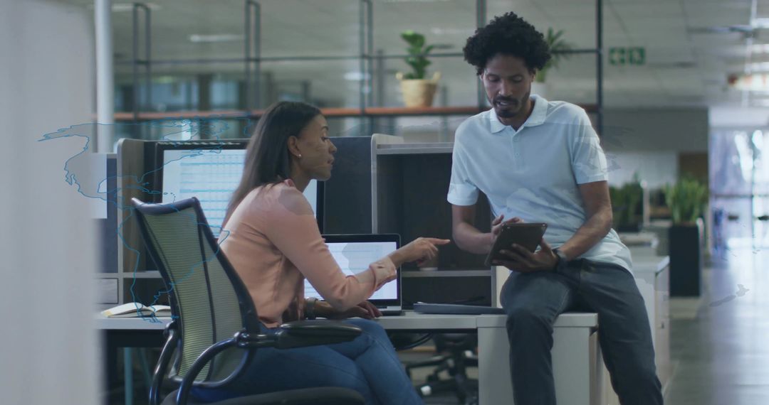 Office Colleagues Collaborating Over Tablet in Open Workspace