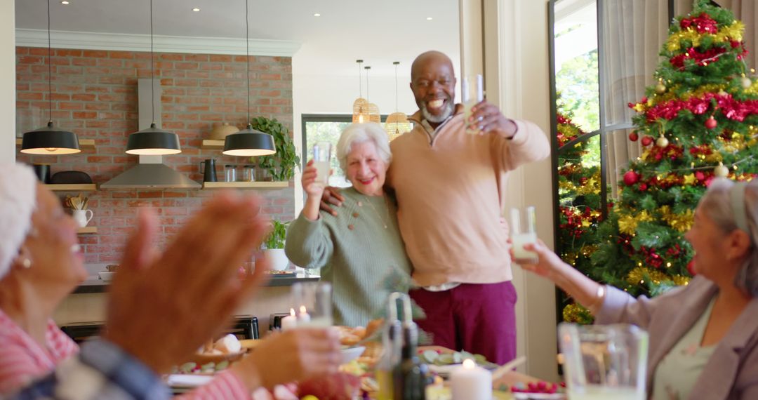 Diverse Senior Couple Celebrating Christmas with Family at Home - Free Images, Stock Photos and Pictures on Pikwizard.com