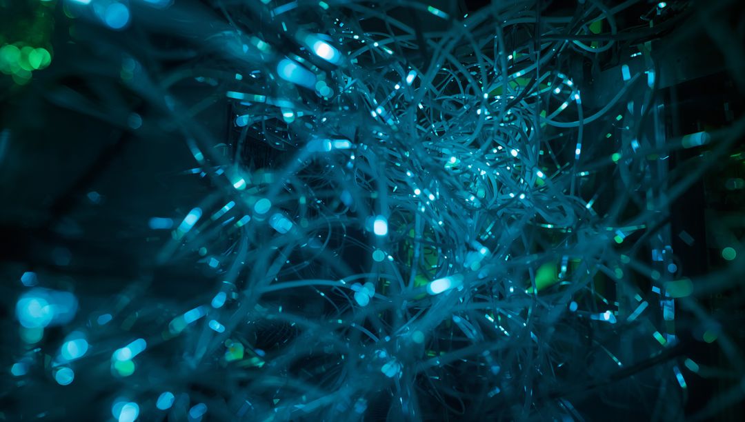 Glowing Teal Fiber Optic Strands Forming Futuristic Abstract Network of Light and Data