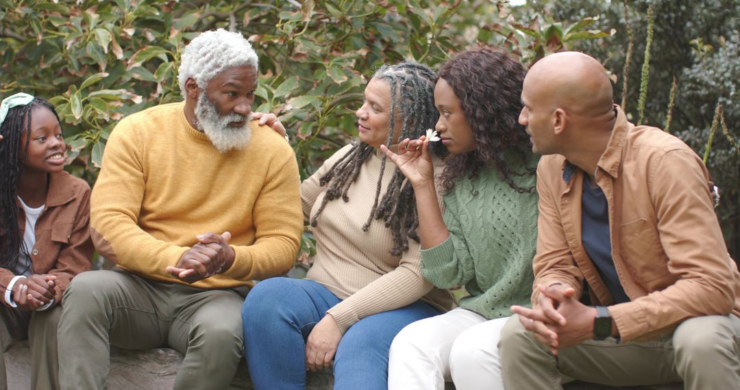 Multigenerational African American Family Sitting Together Outdoors Sharing Quiet Moment