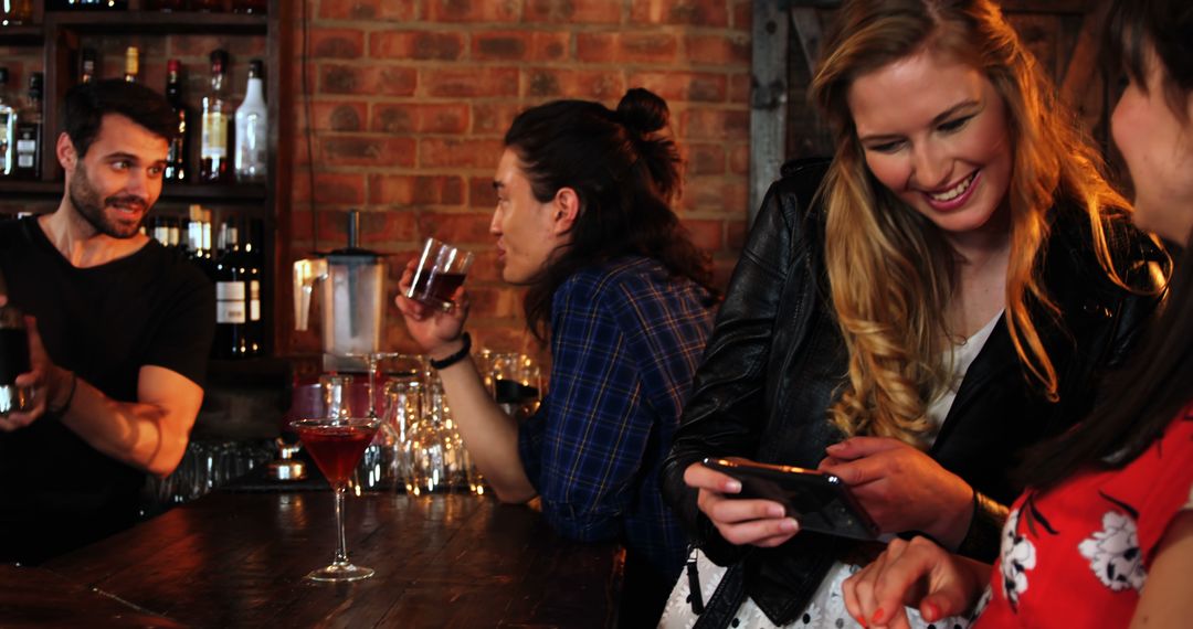 Two Women Taking Selfie in Lively Bar Setting