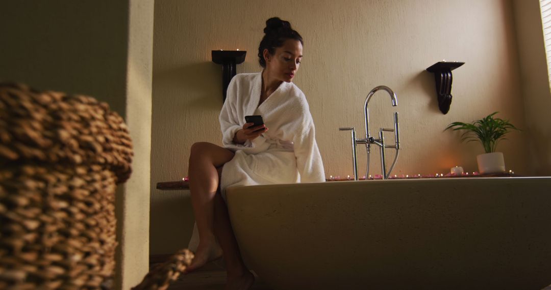 Serene Moment in Home Spa, Woman in Robe Using Smartphone