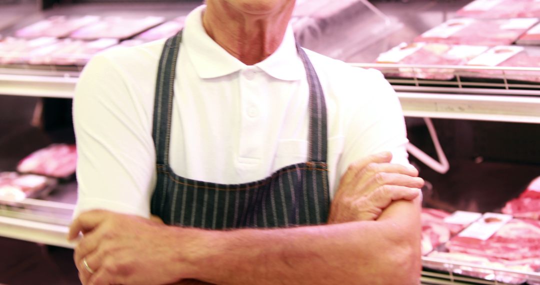 Butcher with Crossed Arms at Meat Market Counter - Free Images, Stock Photos and Pictures on Pikwizard.com