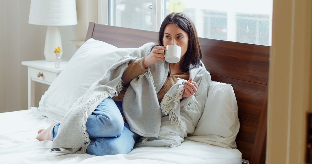 Relaxing Woman Drinking Coffee in Cozy Bedroom - Free Images, Stock Photos and Pictures on Pikwizard.com