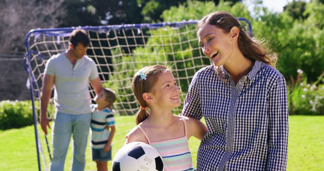 Happy Family Playing Soccer Outdoors on Sunny Day - Free Images, Stock Photos and Pictures on Pikwizard.com