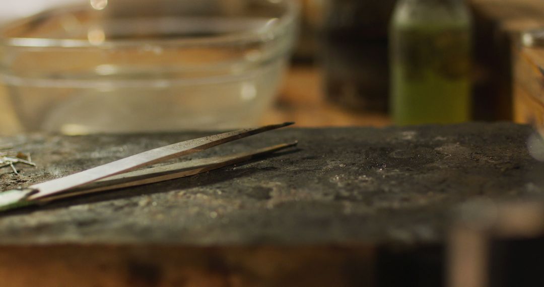Jewelry Workbench Tools Focused on Tweezers in Artisan Workshop