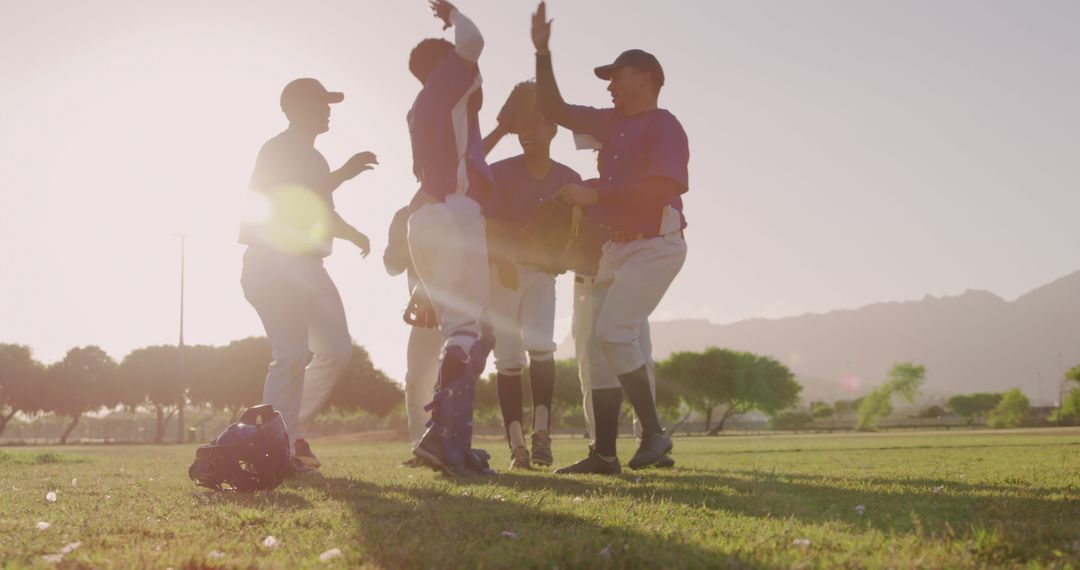 Baseball Team Celebrating Victory on Field During Sunset - Free Images, Stock Photos and Pictures on Pikwizard.com