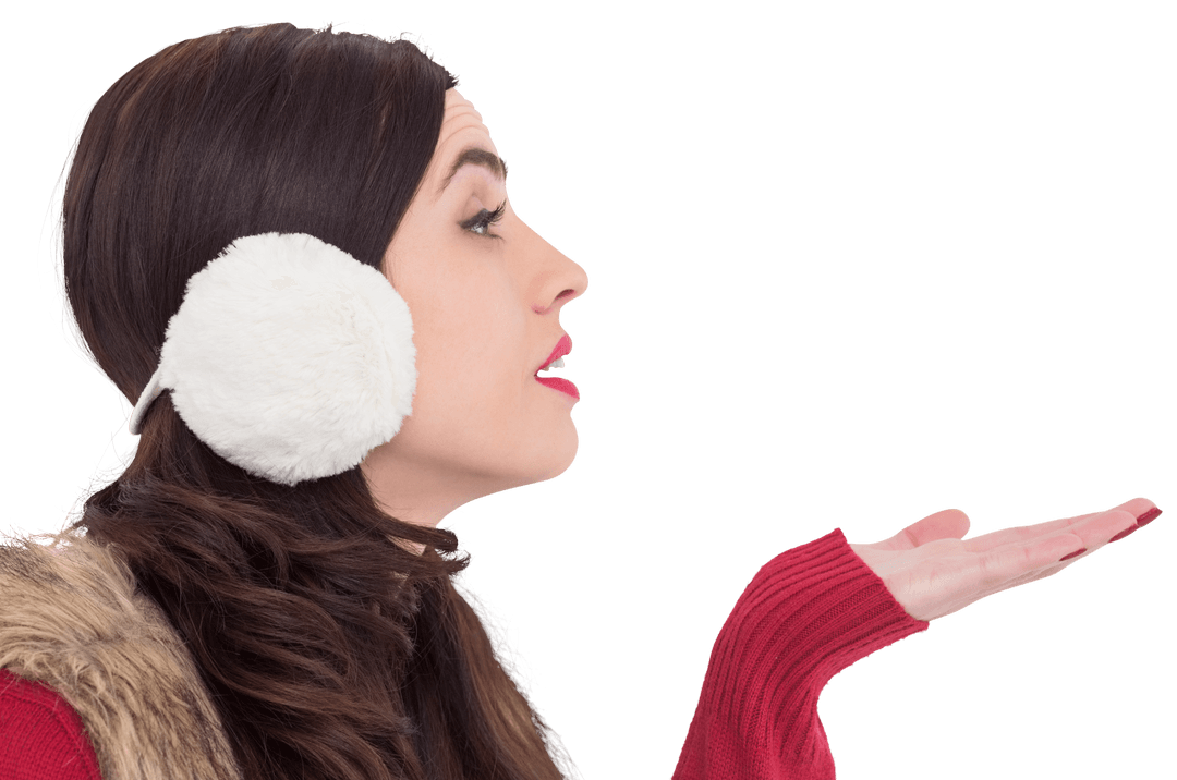 Brunette Woman in Winter Attire Blowing Handful with Transparent Effect