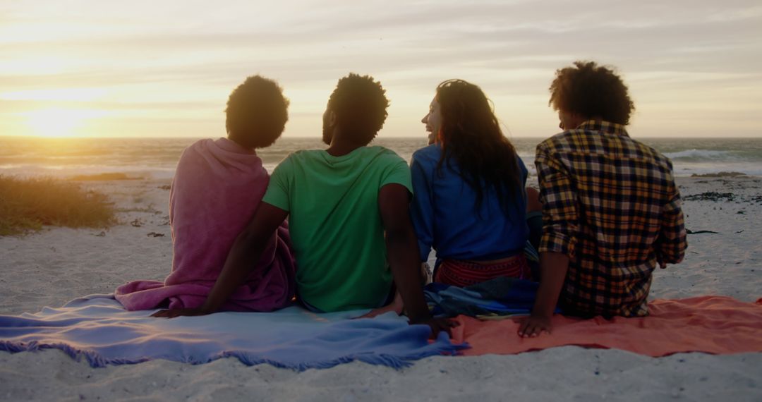 Diverse Friends Bonding While Watching Sunset on Beach - Free Images, Stock Photos and Pictures on Pikwizard.com