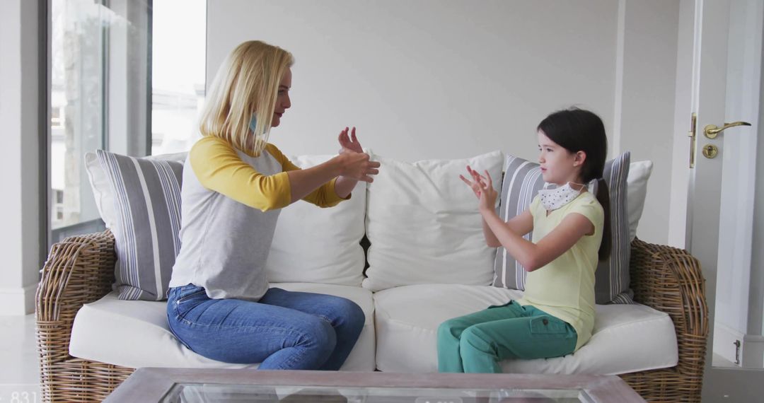 Mother and Daughter Engaged in Sign Language Communication at Home
