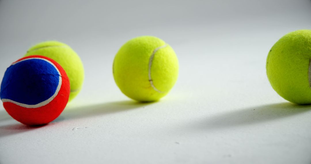 Colorful Tennis Balls Spread Out on White Background - Free Images, Stock Photos and Pictures on Pikwizard.com