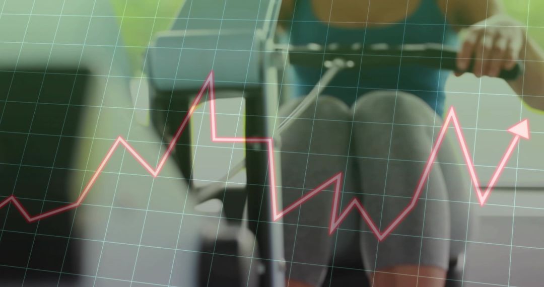 Woman rowing on ergometer showing performance graph, cardio metrics and training progress