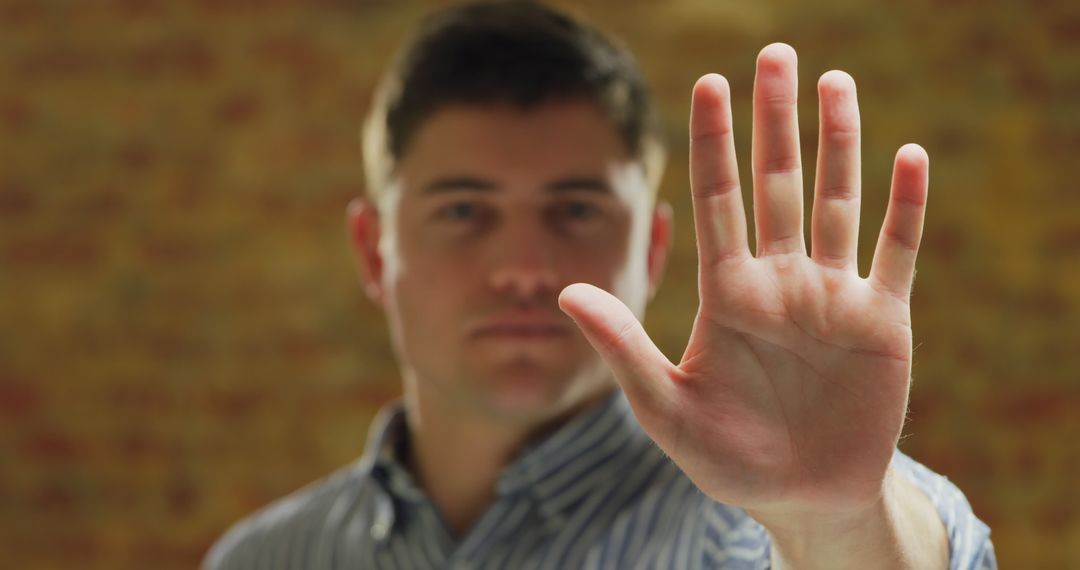 Man Making Stop Gesture With Palm Facing Camera - Free Images, Stock Photos and Pictures on Pikwizard.com