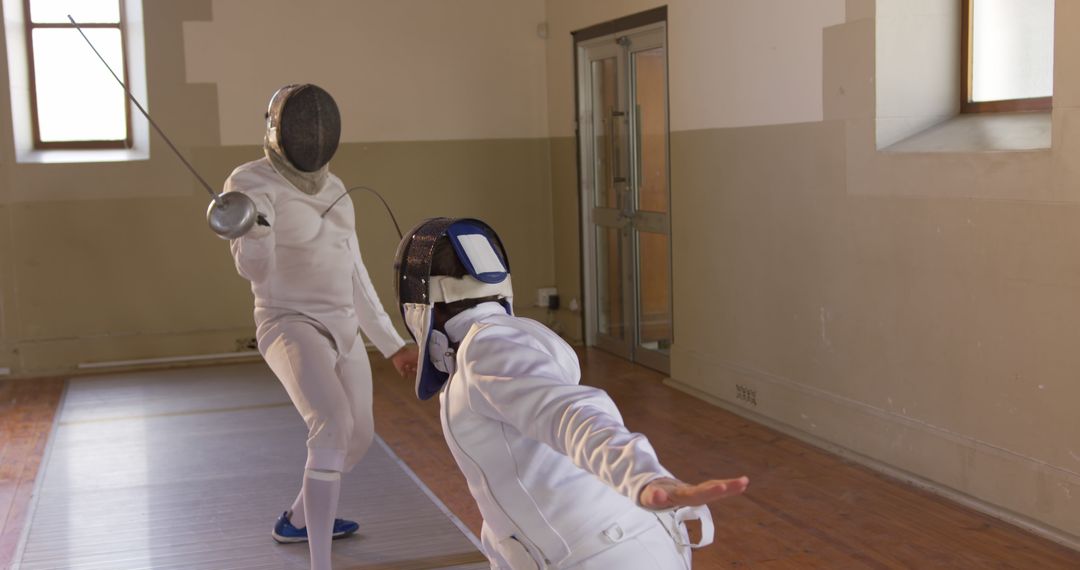 Two Fencers Sparring in Indoor Fencing Hall - Free Images, Stock Photos and Pictures on Pikwizard.com