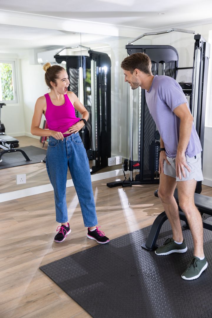 Couple Exercising with Cable Machine in Modern Home Gym