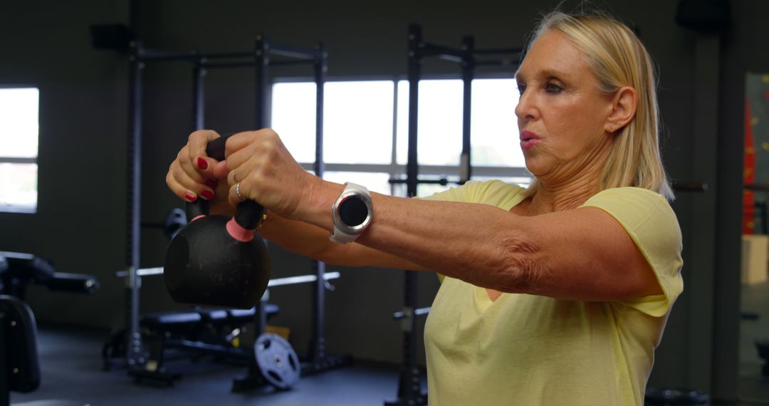 Active Senior Woman Doing Kettlebell Workout at Gym - Free Images, Stock Photos and Pictures on Pikwizard.com