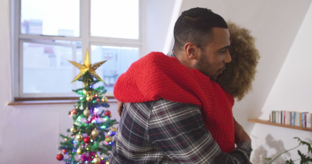 Couple Embracing by Festive Christmas Tree - Free Images, Stock Photos and Pictures on Pikwizard.com