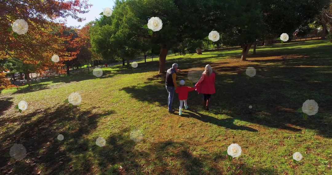Joyful Family Walking in Park with Floating Flowers