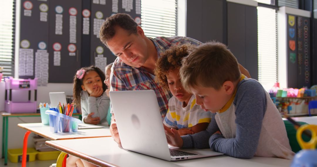 Enthusiastic Teacher Helping Curious Children with Technology
