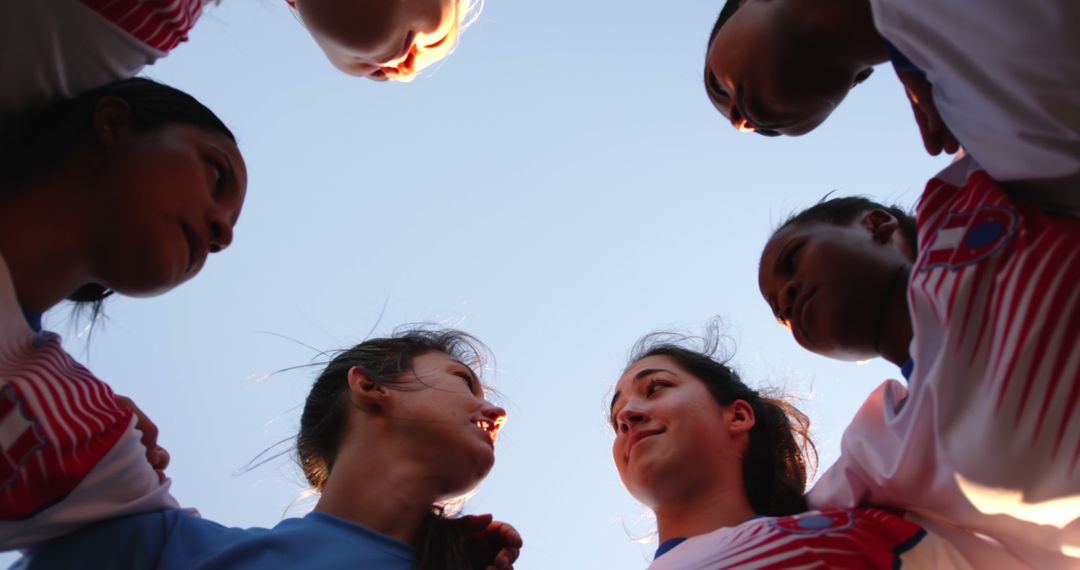 Diverse Female Soccer Team Huddling in Unity, Low Angle View - Free Images, Stock Photos and Pictures on Pikwizard.com