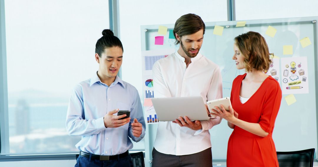 Diverse Business Team Collaborating with Technology in Bright Office