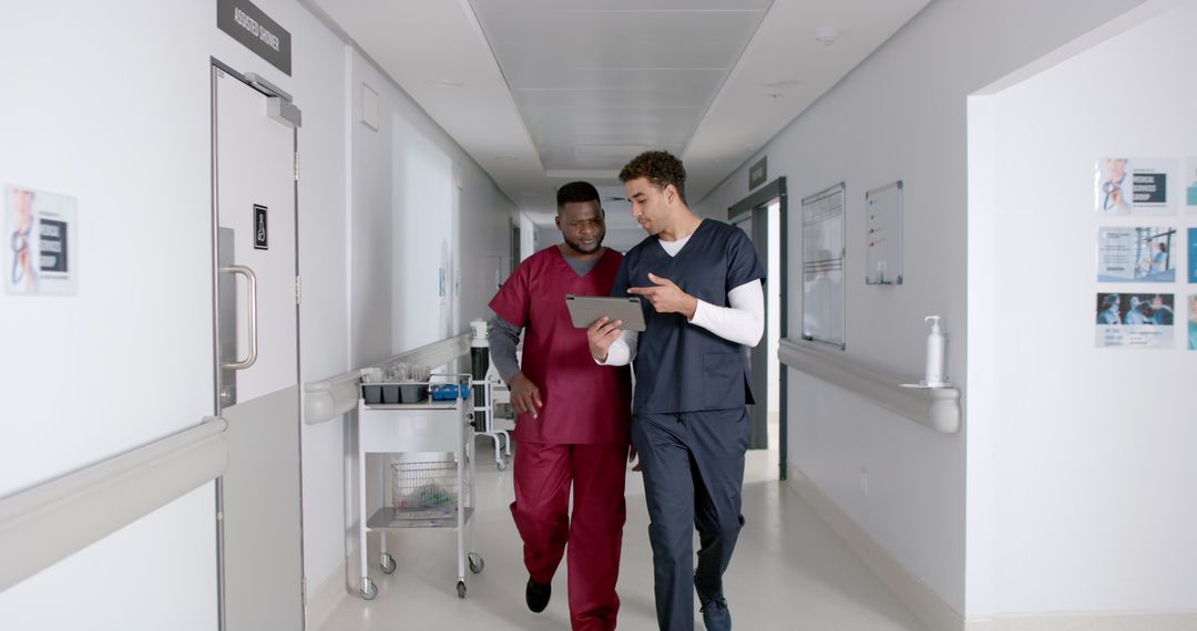 Medical Professionals Collaborating in Hospital Hallway with Tablet