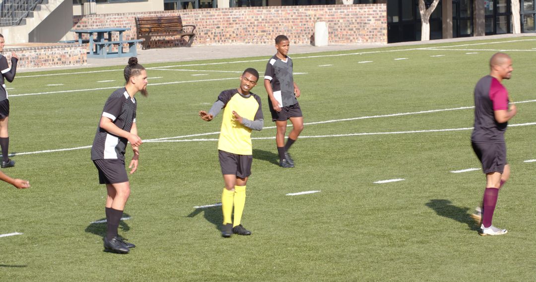 Soccer Players Competing Intensely on Green Field