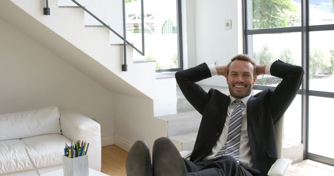 Confident Businessman Relaxing in Modern Office - Free Images, Stock Photos and Pictures on Pikwizard.com