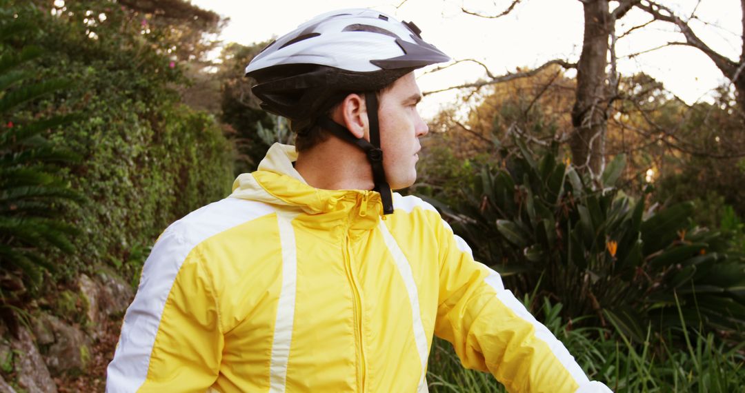 Cyclist in Yellow Jacket Enjoying Nature - Free Images, Stock Photos and Pictures on Pikwizard.com