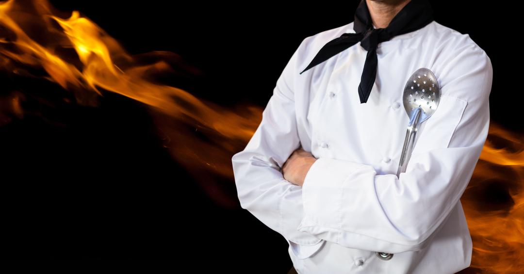 Confident Chef Holding Skimmer with Flames in Background - Free Images, Stock Photos and Pictures on Pikwizard.com