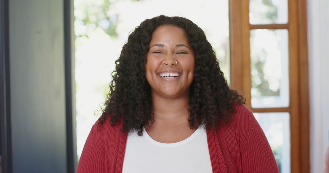 Joyful Biracial Woman Smiling Indoors with Confidence - Free Images, Stock Photos and Pictures on Pikwizard.com