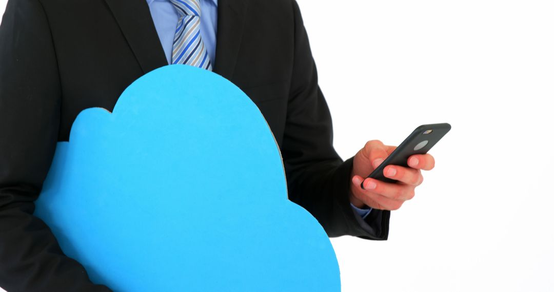 Businessman Holding Cloud Symbol and Mobile Phone - Free Images, Stock Photos and Pictures on Pikwizard.com