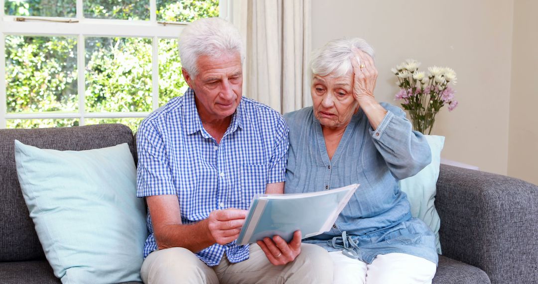 Senior Couple Reviewing Documents in Living Room - Free Images, Stock Photos and Pictures on Pikwizard.com