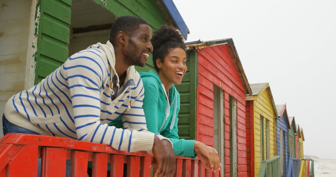 Couple Enjoying Vibrant Beach Huts on Leisurely Vacation - Free Images, Stock Photos and Pictures on Pikwizard.com