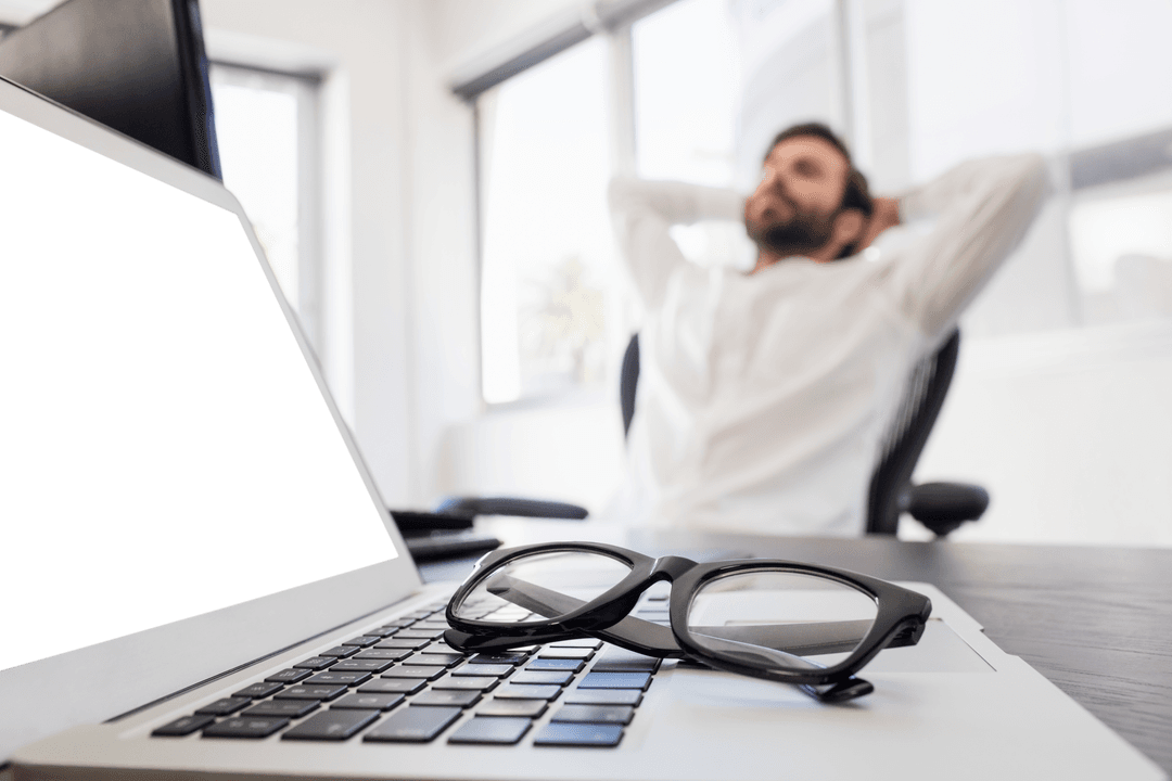 Businessman Relaxing with Transparent Eyeglasses On Laptop