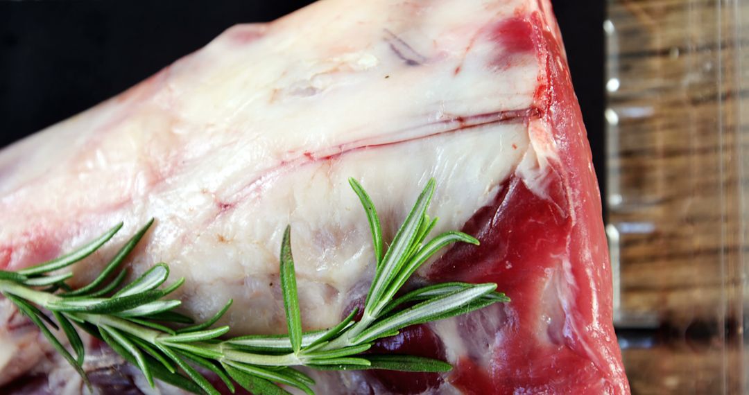 Close-up of Raw Lamb Shoulder with Fresh Rosemary and Natural Marbling Detail - Free Images, Stock Photos and Pictures on Pikwizard.com