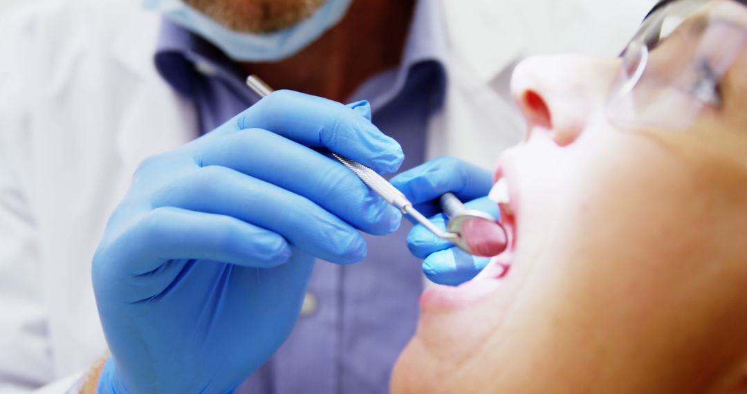 Dentist Treating Patient Using Dental Tools - Free Images, Stock Photos and Pictures on Pikwizard.com