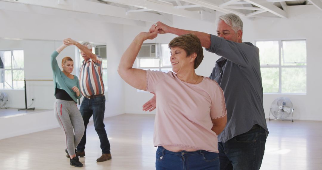 Senior Couples Enjoying Ballroom Dance Class with Smiles
