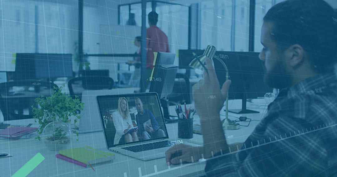 Bearded Man Conducting Virtual Meeting in Modern Office Context