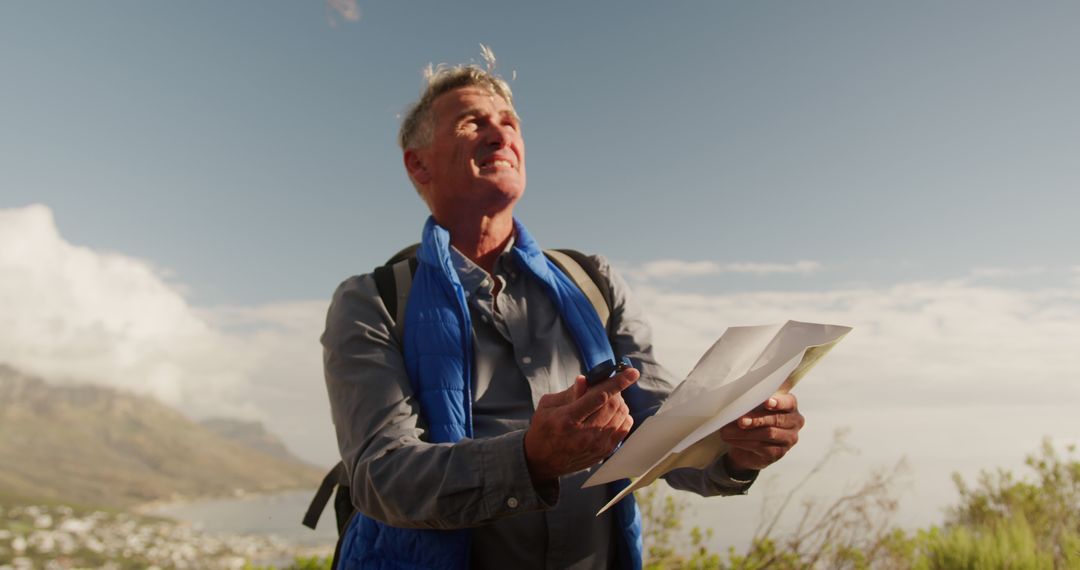 Senior Man Navigating with Map on Mountainous Hike - Free Images, Stock Photos and Pictures on Pikwizard.com