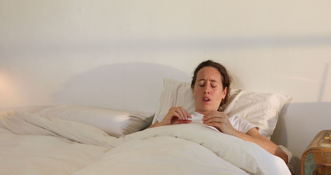 Young Woman Feeling Unwell and Resting in Bed with Tissue - Free Images, Stock Photos and Pictures on Pikwizard.com