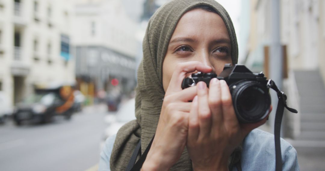 Young Woman Wearing Hijab Taking Photographs in Urban Area - Free Images, Stock Photos and Pictures on Pikwizard.com