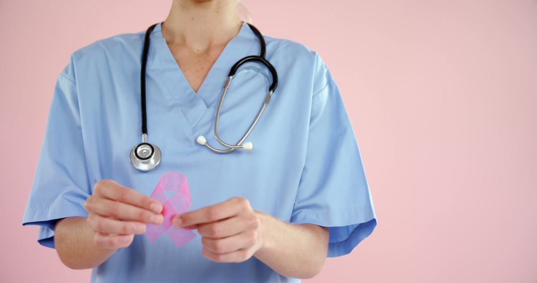 Healthcare Professional Holding Breast Cancer Awareness Ribbon - Free Images, Stock Photos and Pictures on Pikwizard.com