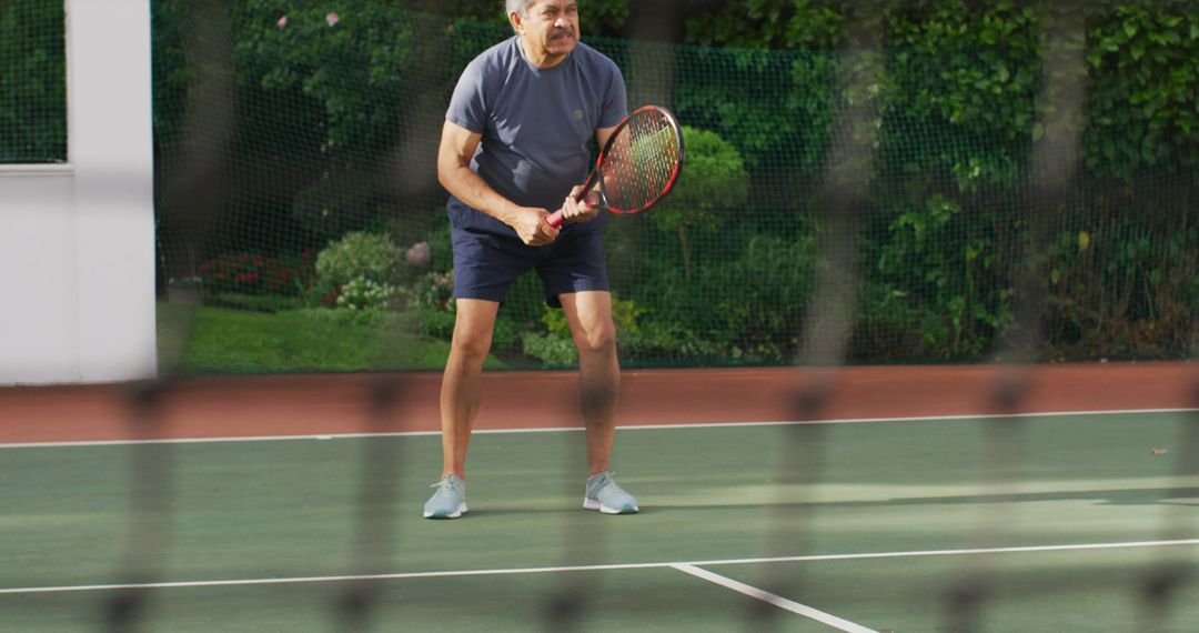 Focused Elderly Man Playing Tennis on Court: Active Seniors, Retirement, Tennis Training Concept - Free Images, Stock Photos and Pictures on Pikwizard.com