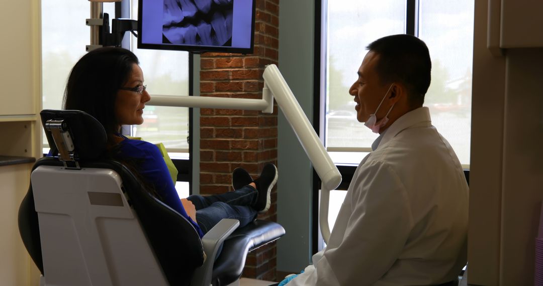 Dentist Consults Patient in Modern Dental Office - Free Images, Stock Photos and Pictures on Pikwizard.com